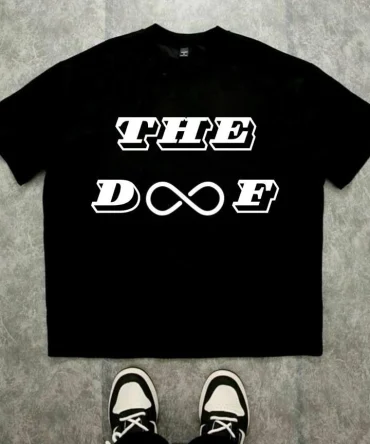 Le t-shirt ABDOU : pour les esprits sans limites qui vivent à l'infini. Ce t-shirt affiche « THE DOOF » en typographie bold italique percutante sur deux lignes, avec le symbole de l'infini ∞ intégré au cœur du mot, remplaçant le « OO ». Un design qui dit tout sans un mot de trop.